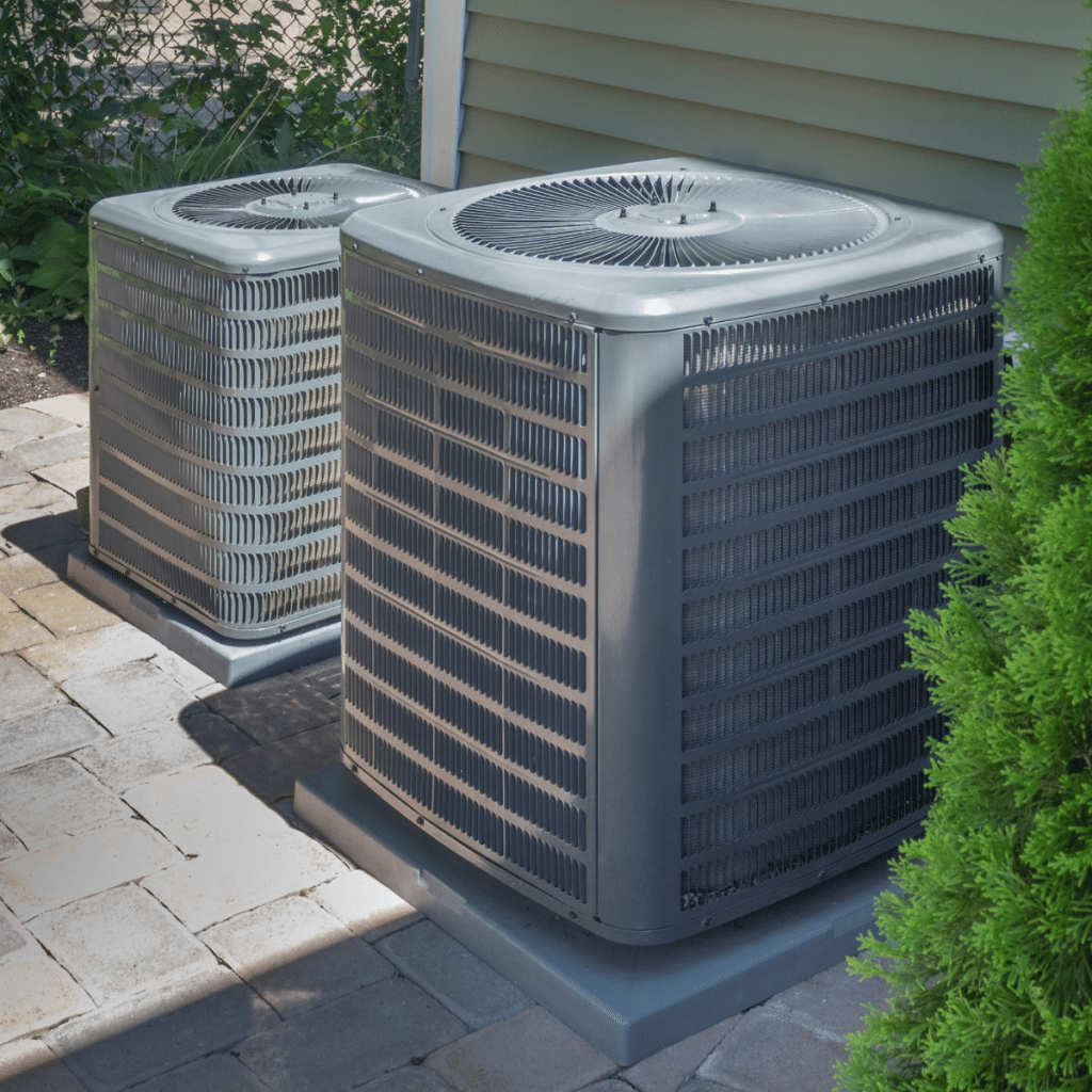 two outdoor HVAC units side by side against a Pennsylvania home