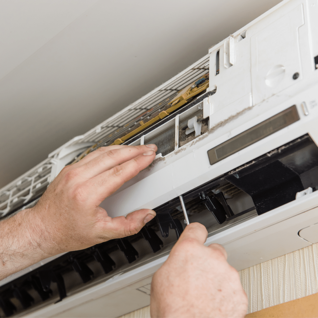 hands of a service technician adjusting a heater during repair services