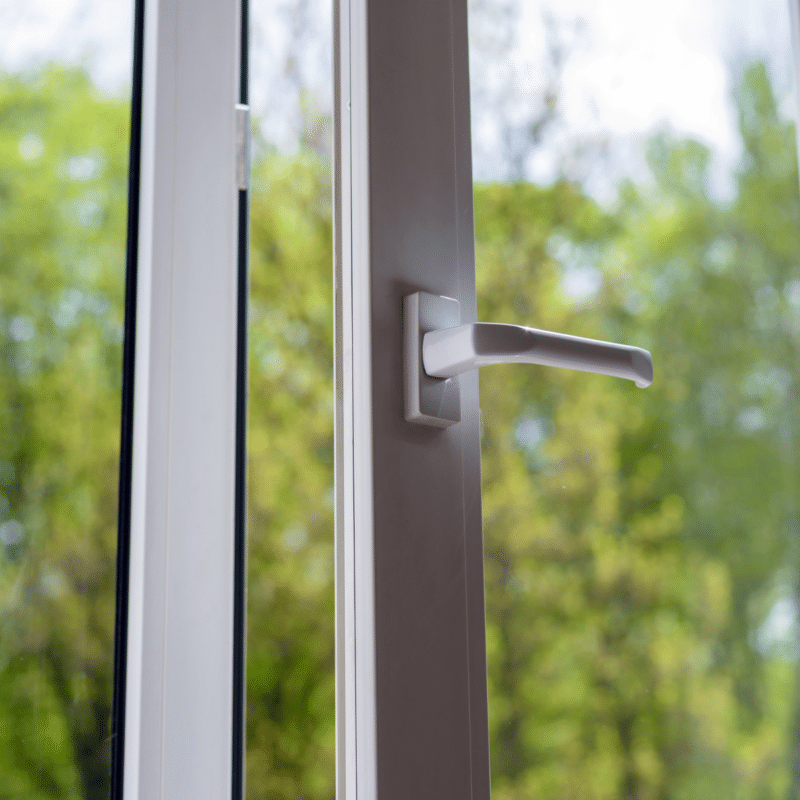 an open door with clear windows showing the trees outside