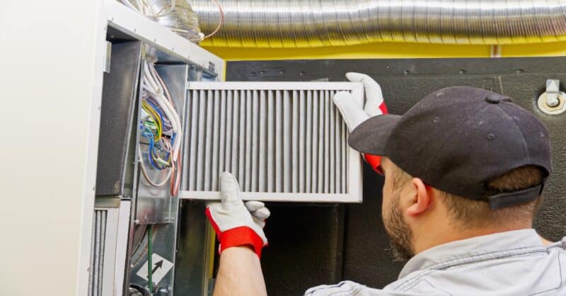 furnace tech installing a filter