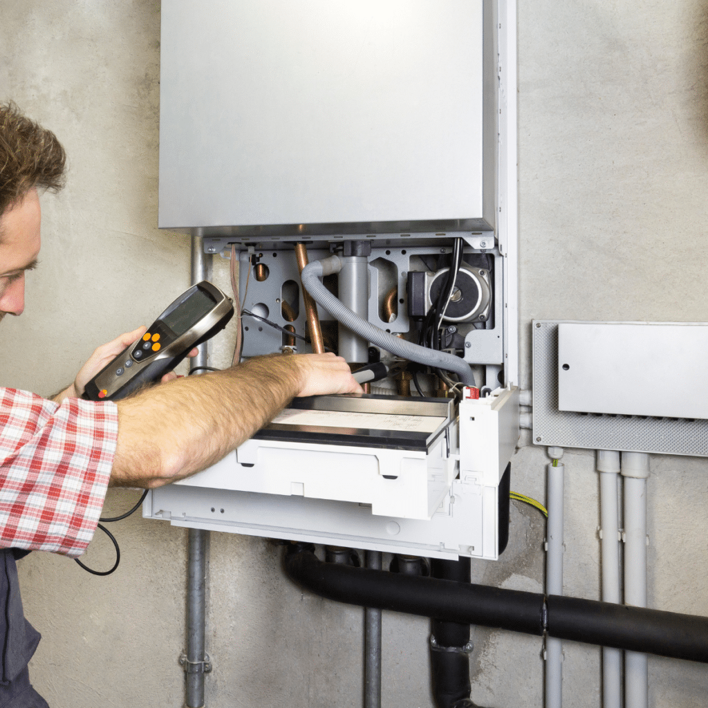 Technician using a tool to check and repair a gas boiler system